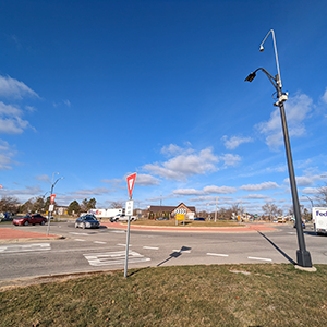 Photograph of a roundabout at State Street and Ellsworth Road. It features the Smart Intersections Project equipment.