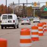 Three research vehicles drive down a stretch of highway.